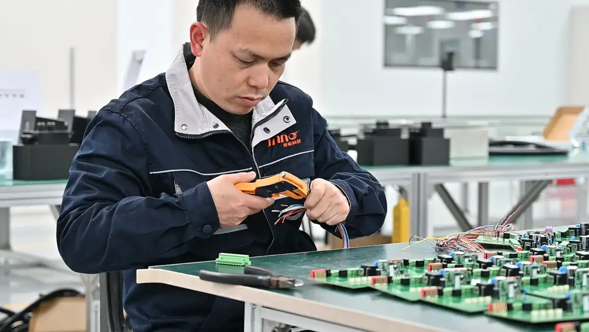 INNO technician assembling temperature monitoring electronics